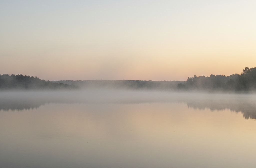 Still water at dawn representing complex trauma healing and recovery for women